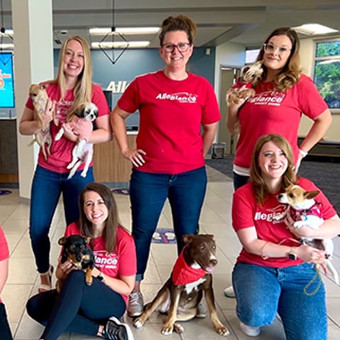 Allegiance employees pose with pets in the office