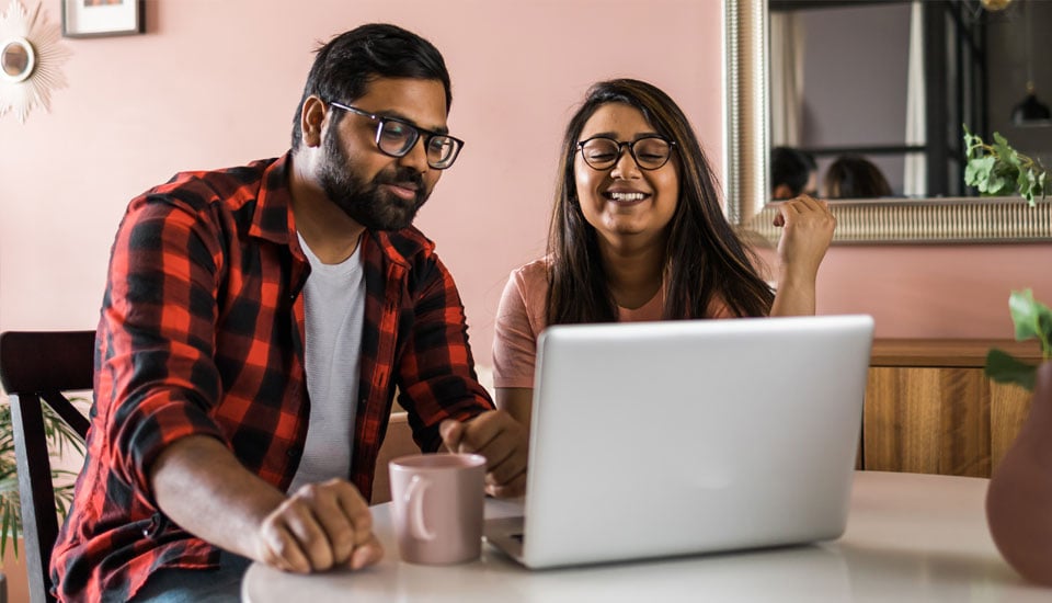 Couple-applying-for-a-credit-union-auto-loan-online-together-at-the-kitchen-table.